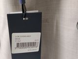 a tag on the back of a white shirt
