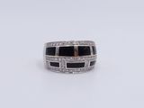 a close up of a ring with black and white stones