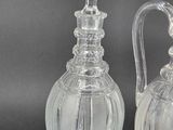 pair of clear glass vases on black background with grey background