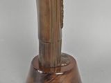statue of a woman holding a glass of wine on a wooden base