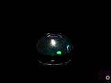 an oplite is glowing in the dark on a black surface