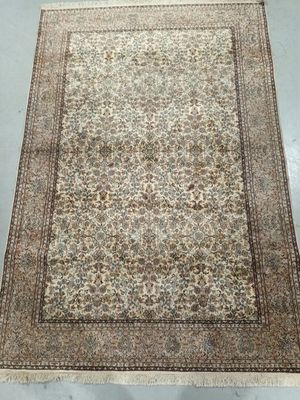 a large rug with a floral design on a white ground