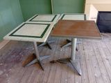 two tables that are sitting on the floor in the room