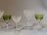 six wine glasses lined up on a white table