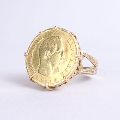 an image of a gold coin ring with a woman ' s face on it