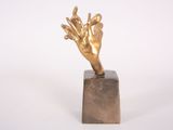 statue of a hand on a marble block on a white background