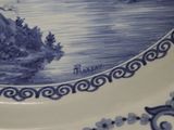a blue and white plate with a picture on it