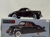 an old model of a black car sitting on top of a box