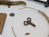a table with various items on it including a key, a book, and other items