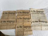 several newspapers sitting on top of a table on top of a white table