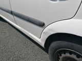 a picture of a white car parked on the side of the road