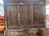 a large wooden bed in a room with a lot of furniture
