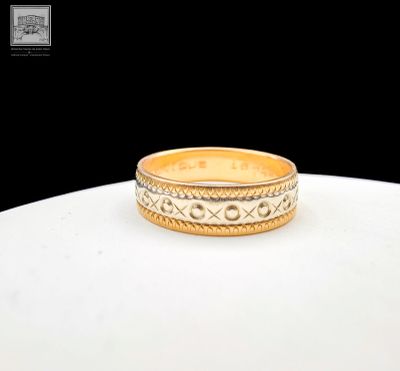 an image of a gold wedding ring on a table