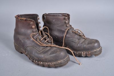 a pair of brown boots with laces on them