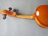 a close up of a violin on a gray surface