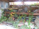 a pile of old dishes sitting on a shelf next to a window