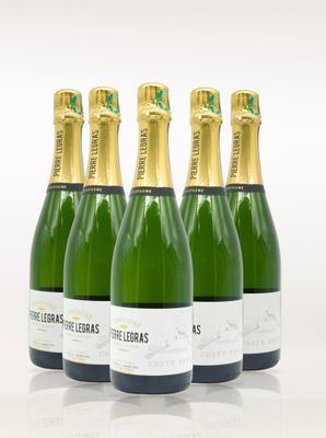 four bottles of champagne are lined up on a white surface