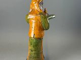 a figurine of a man holding a bird in his hand