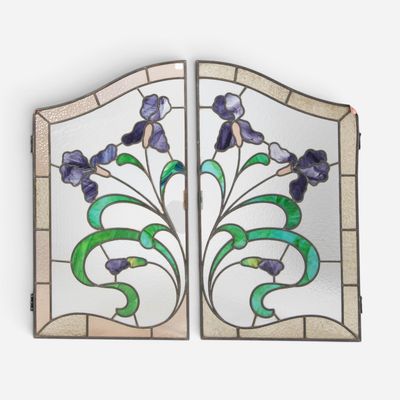 a close up of a stained glass window with flowers on it