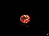 a close up of a red diamond on a black surface