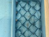 a blue box with a blue cloth inside of it