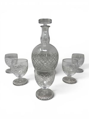 bottles and glasses on a white surface with a white background