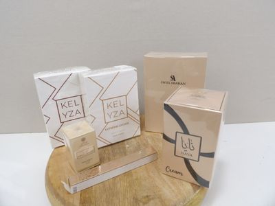 three boxes of kel yaz on a wooden stand next to a box of kel yaz