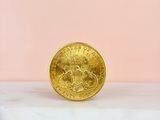a gold coin sitting on top of a marble counter top