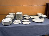 a lot of plates on a table with a blue table cloth