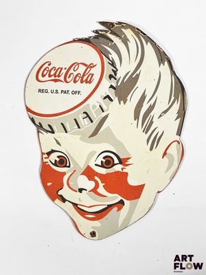 a paper cutout of a boy with a coca cola cap on his head
