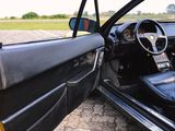 the interior of a car with the door open and the steering wheel down