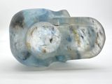 a blue and white glass object on a white surface