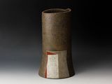 brown and white vase with a red stripe on the side