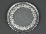 a silver plate with a design on it on a table