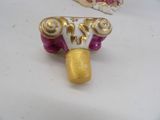 two gold and pink rings on a white surface