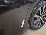 a close up of a car tire with a sticker on it