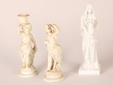 three statues of jesus and a woman on pedestals against a white background