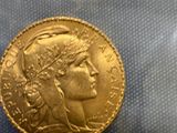 a close up of a gold coin with a woman ' s face on it