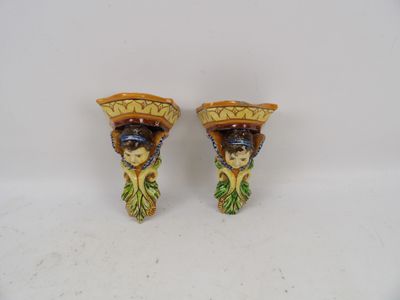 pair of ceramic figurines of a woman with a basket on her head
