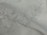 a close up of a bed with a white comforter on it