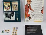 two books on the table and one has a picture of a man with a dog