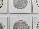 six different types of chinese coins are displayed in a display case