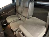four seats in the back of a car with a cup holder