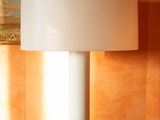 a lamp that is sitting on a table next to a chair