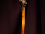 a wooden stick on a table with a purple curtain in the background
