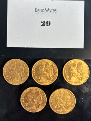 six gold sovereigns in a display case with a price tag