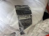 a bag of pillows and a pillow on a bed