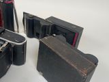 several pieces of black luggage sitting on top of a white surface