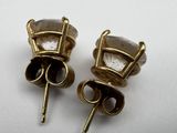 two pairs of gold tone earrings with clear crystals on them