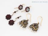 four pairs of earrings with pearls and garnets on a white surface